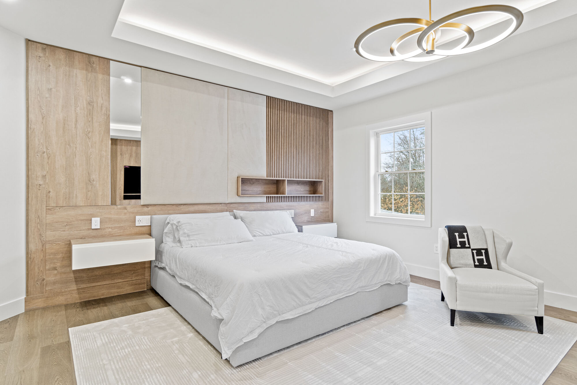 Minimalist bedroom with wood feature wall and built-in storage by designlab in Northern Virginia