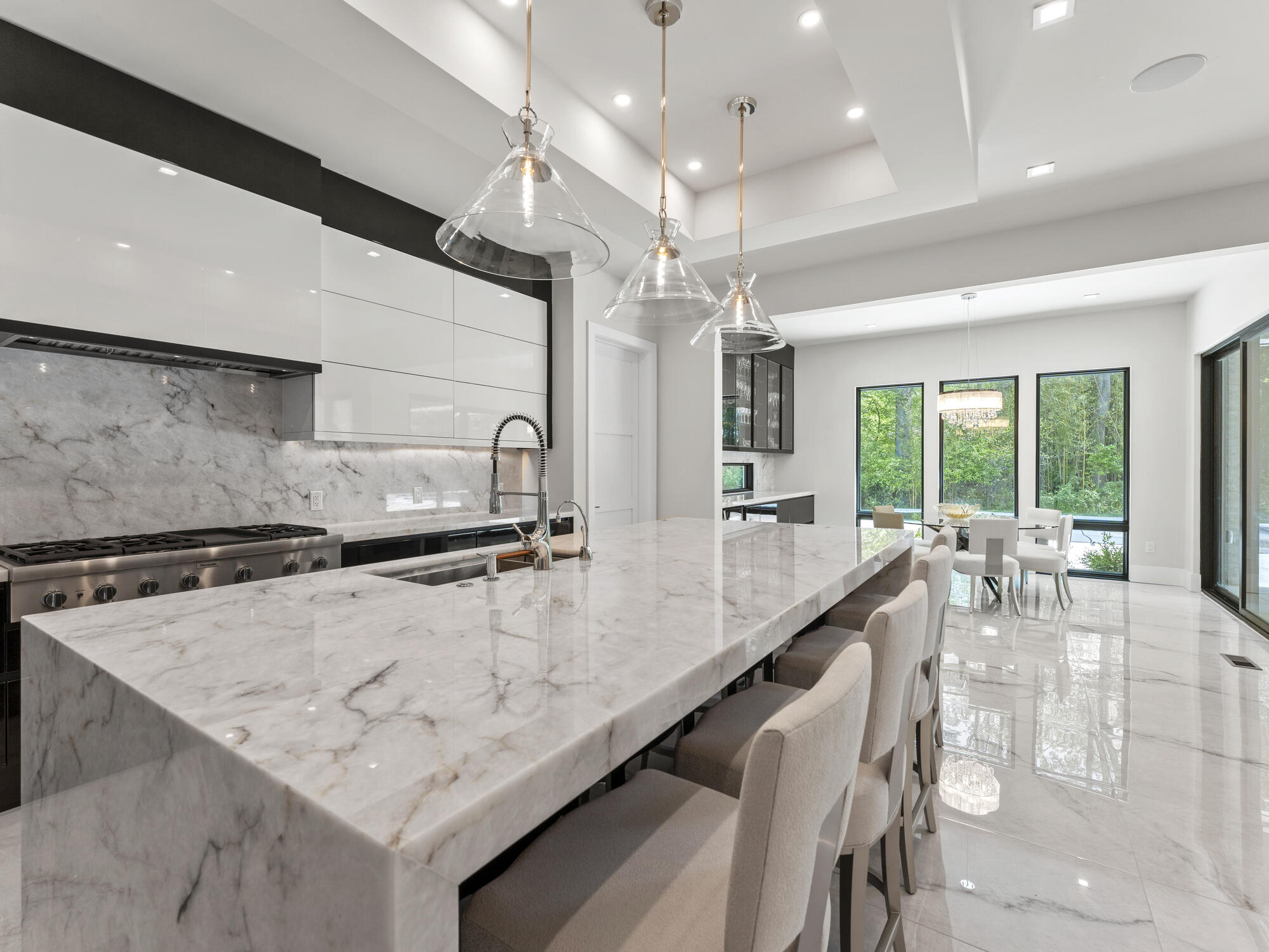 Open-plan kitchen with glass accents and luxury stone finishes in a DesignLab home in Kalorama, DC