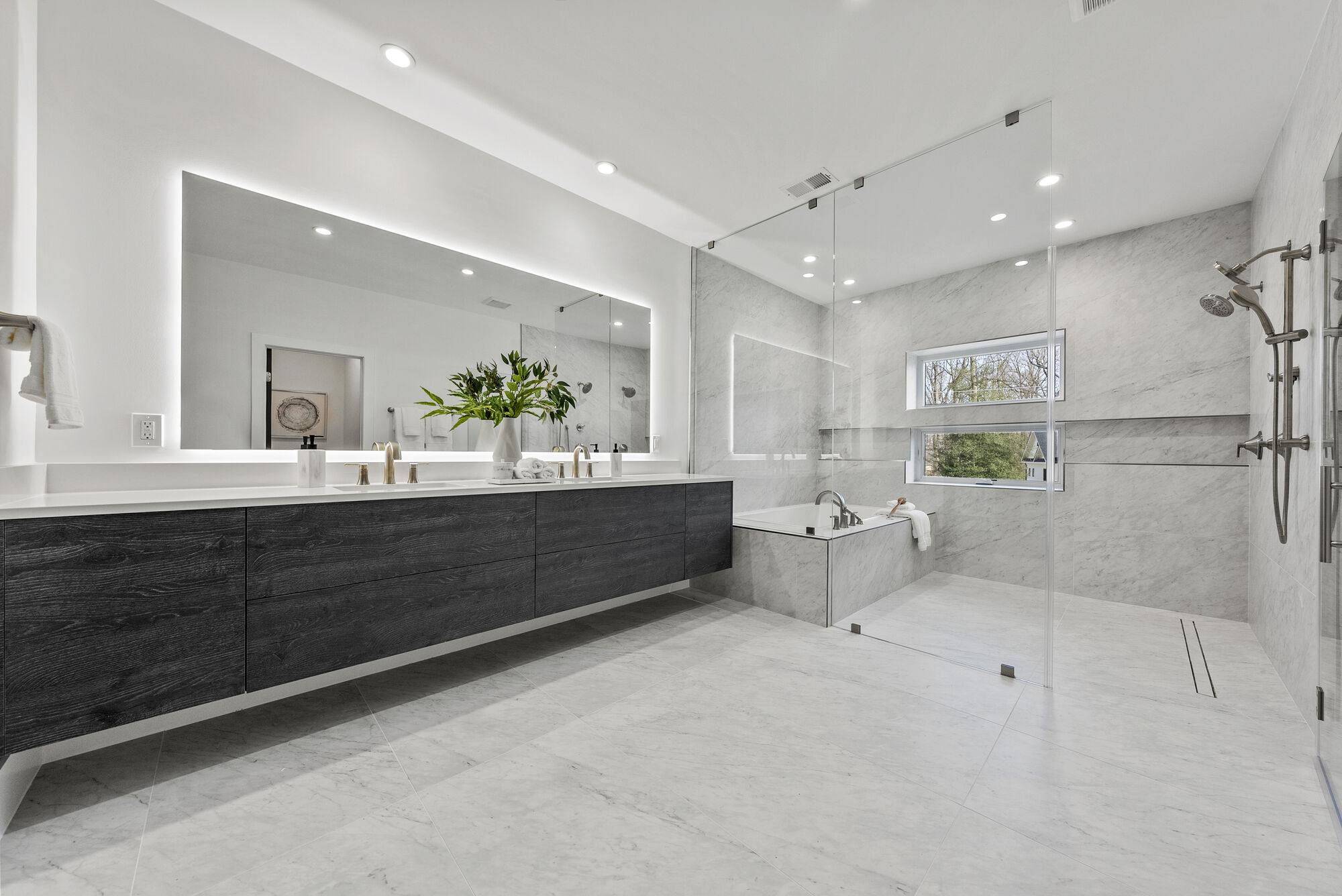 Spacious luxury bathroom in River Oaks home by DesignLab with large shower and soaking tub