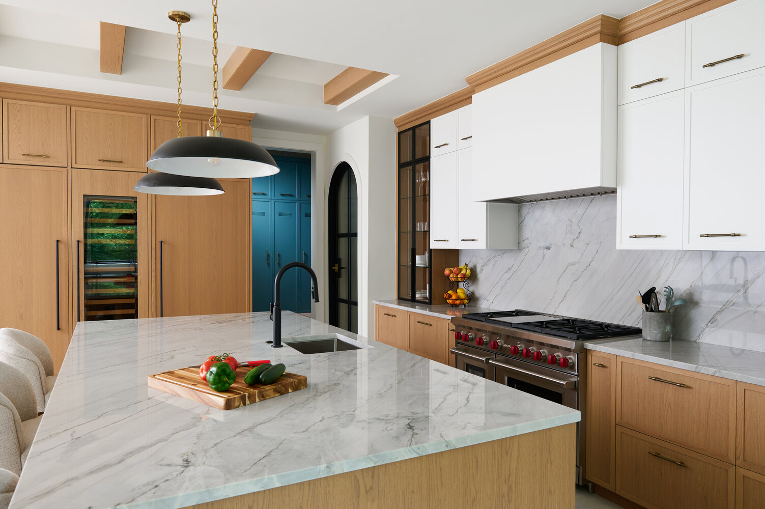 Full kitchen view in custom home by DesignLab in Metro Washington with dual pendant lights and modern wine fridge