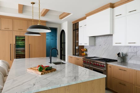 Full kitchen view in custom home by DesignLab in Metro Washington with dual pendant lights and modern wine fridge