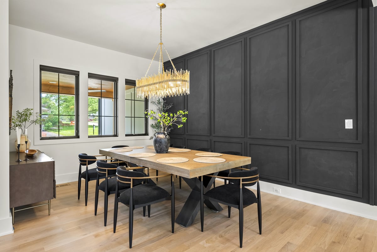 Remodeled dining room with black wall paneling and light wood flooring by DesignLab in Vienna, VA