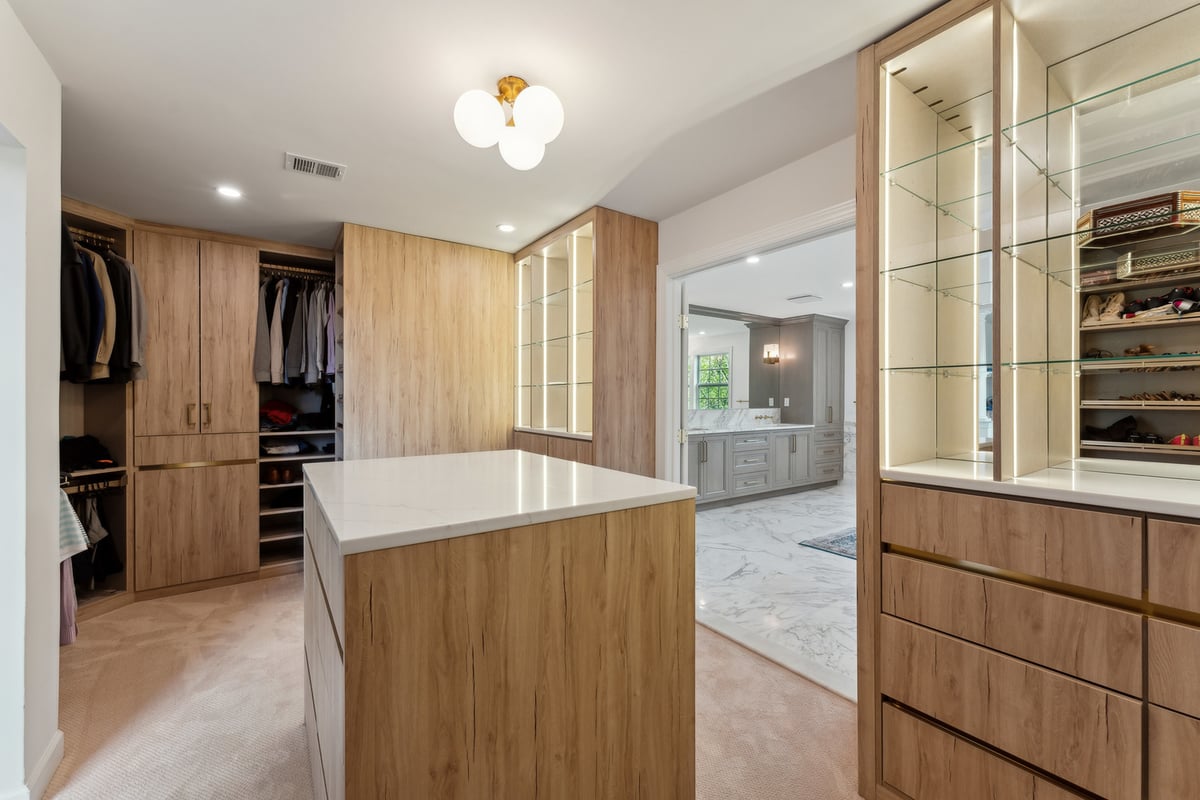 Walk-in closet in DC Metro home with built-in storage designed by DesignLab