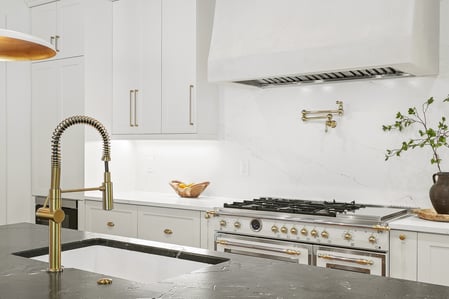 Remodeled kitchen in Vienna, VA with gold finishes white cabinetry