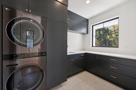 Custom home laundry space with black cabinetry and natural light in a DesignLab project in Georgetown, DC
