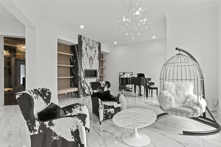 Black and white lounge with accent chairs and marble coffee table in designlabs Northern Virginia remodel