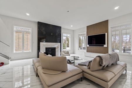 Contemporary living room with marble fireplace and mounted TV in Northern Virginia whole home remodel by designlab