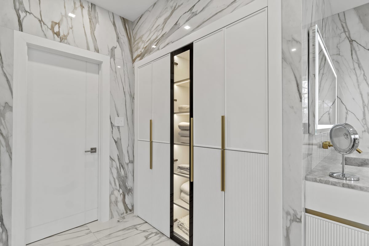Modern bathroom storage with illuminated towel shelving by designlab in Northern Virginia