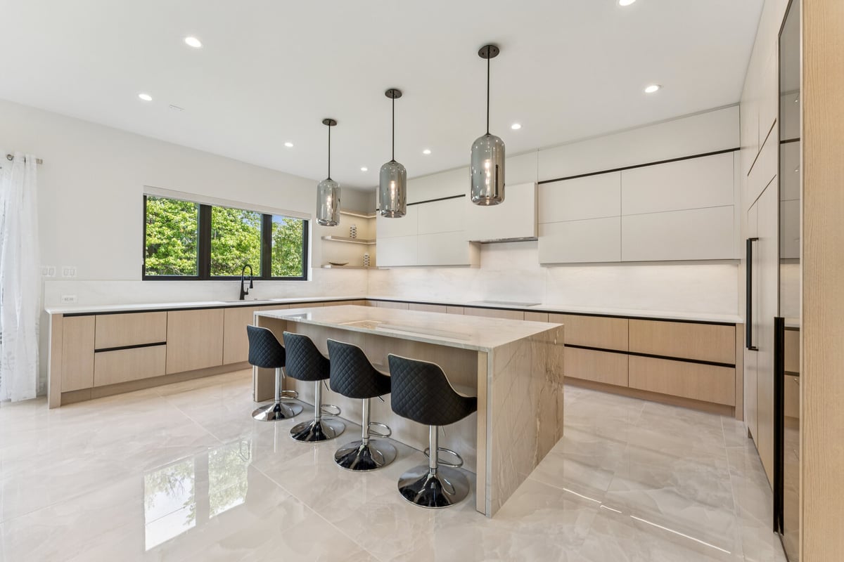 Bright custom kitchen renovation with marble island by DesignLab in Bethesda, Maryland