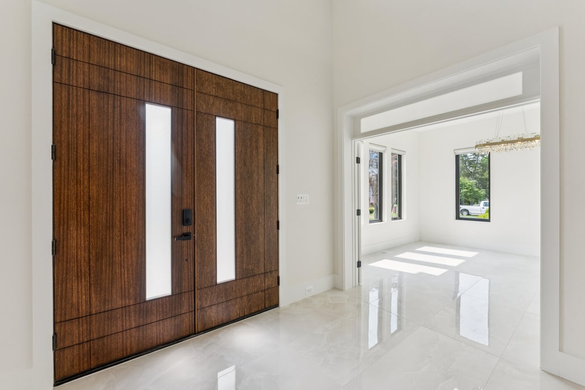 Stylish custom home entryway with wood double doors by DesignLab in Kalorama