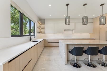 Stylish marble island and black stools in a kitchen remodel by DesignLab, Arlington, Virginia