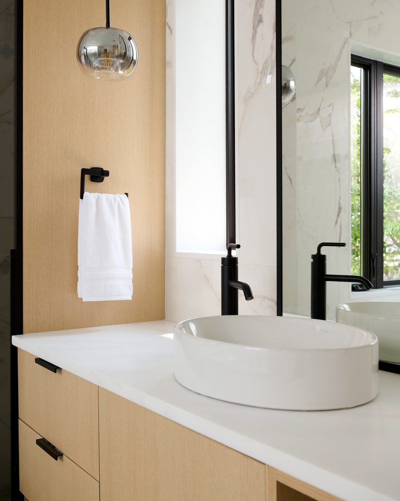 White vessel sink and wall-mounted fixtures in a custom bathroom by DesignLab in Oakton, VA