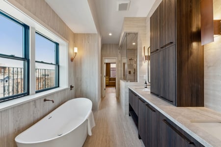 Luxury bathroom with freestanding tub and modern fixtures in a Rhode Island home by DesignLab