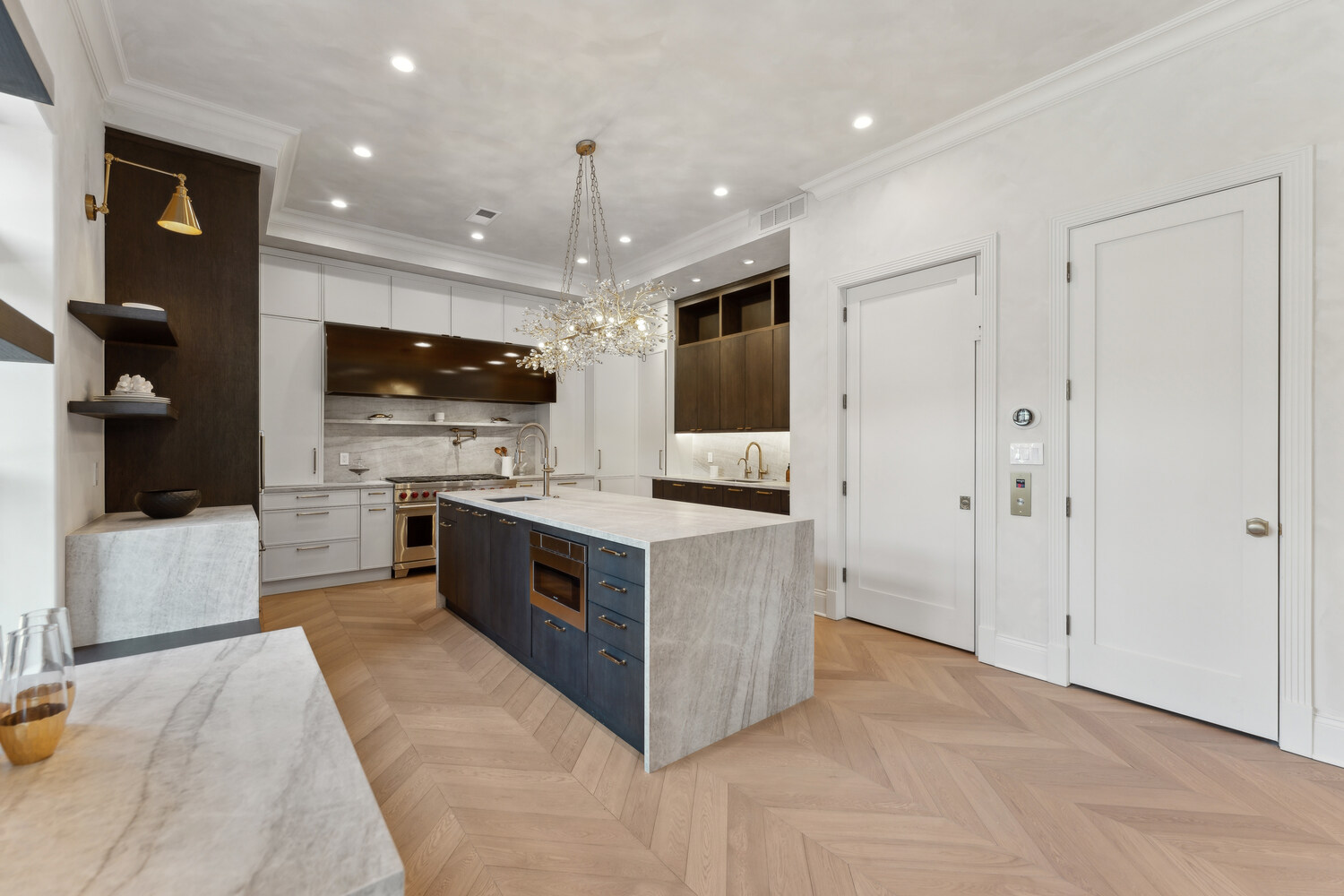Luxury kitchen with herringbone floors and high-end appliances in a DesignLab custom home in Rhode Island