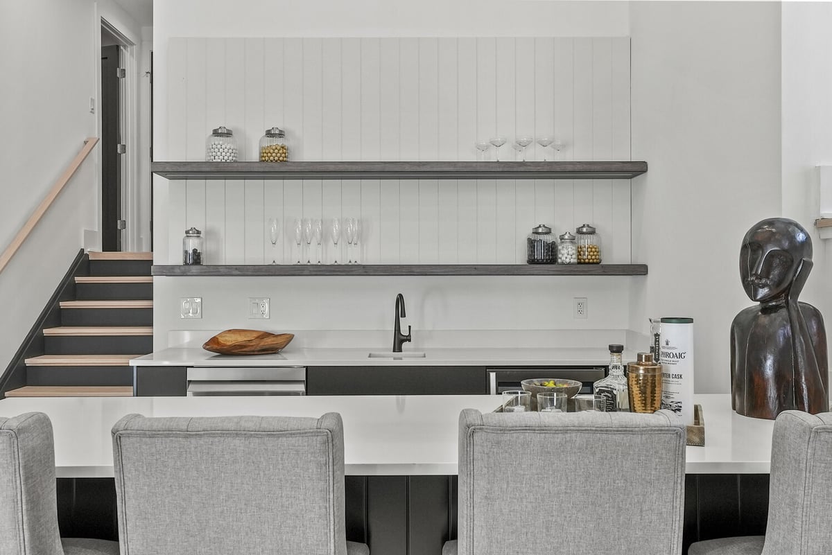 Close-up of modern home bar with black faucet and shelving by DesignLab in Vienna, VA