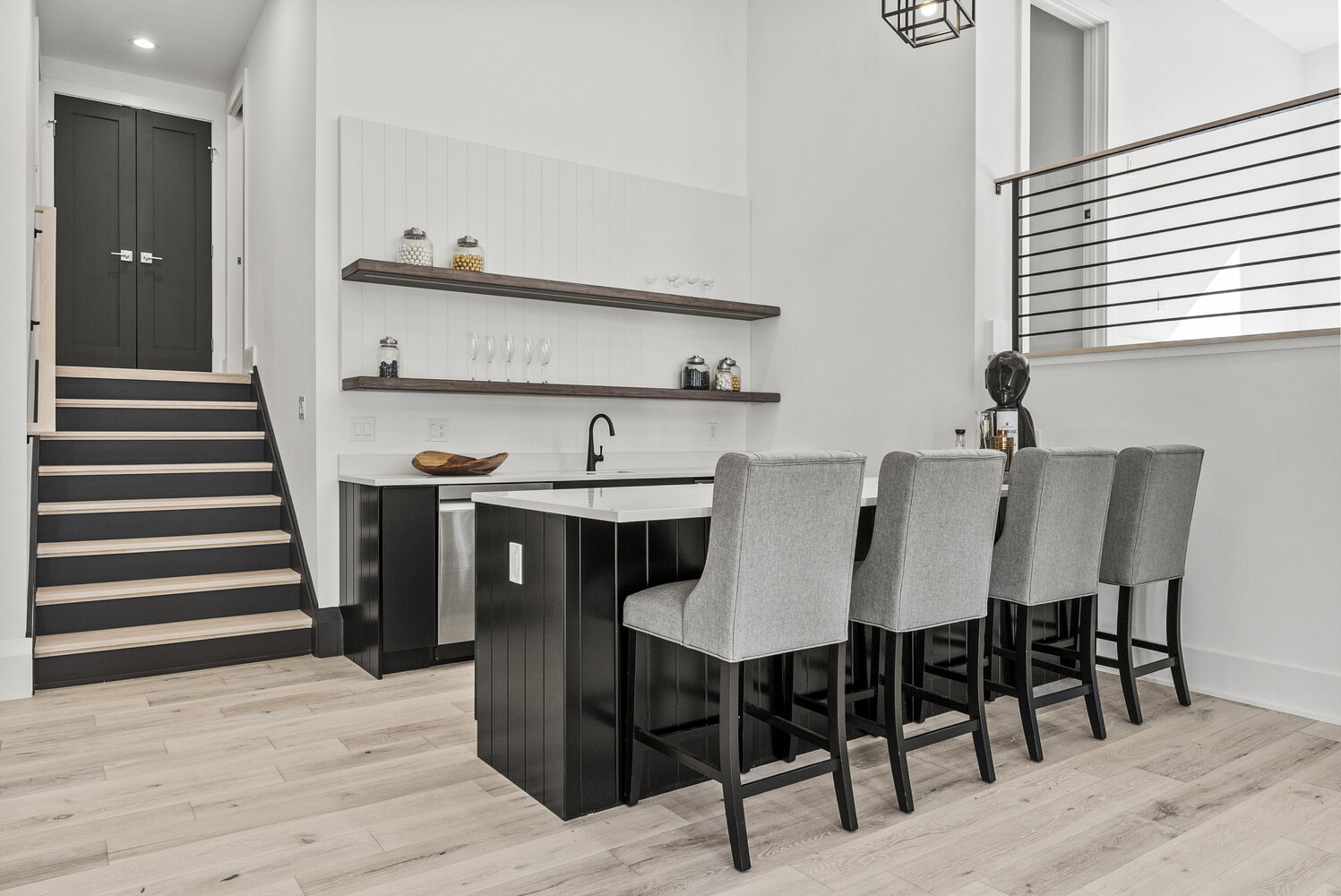 Downstairs bar area with floating wood shelves and seating in a custom DesignLab home in McLean, VA