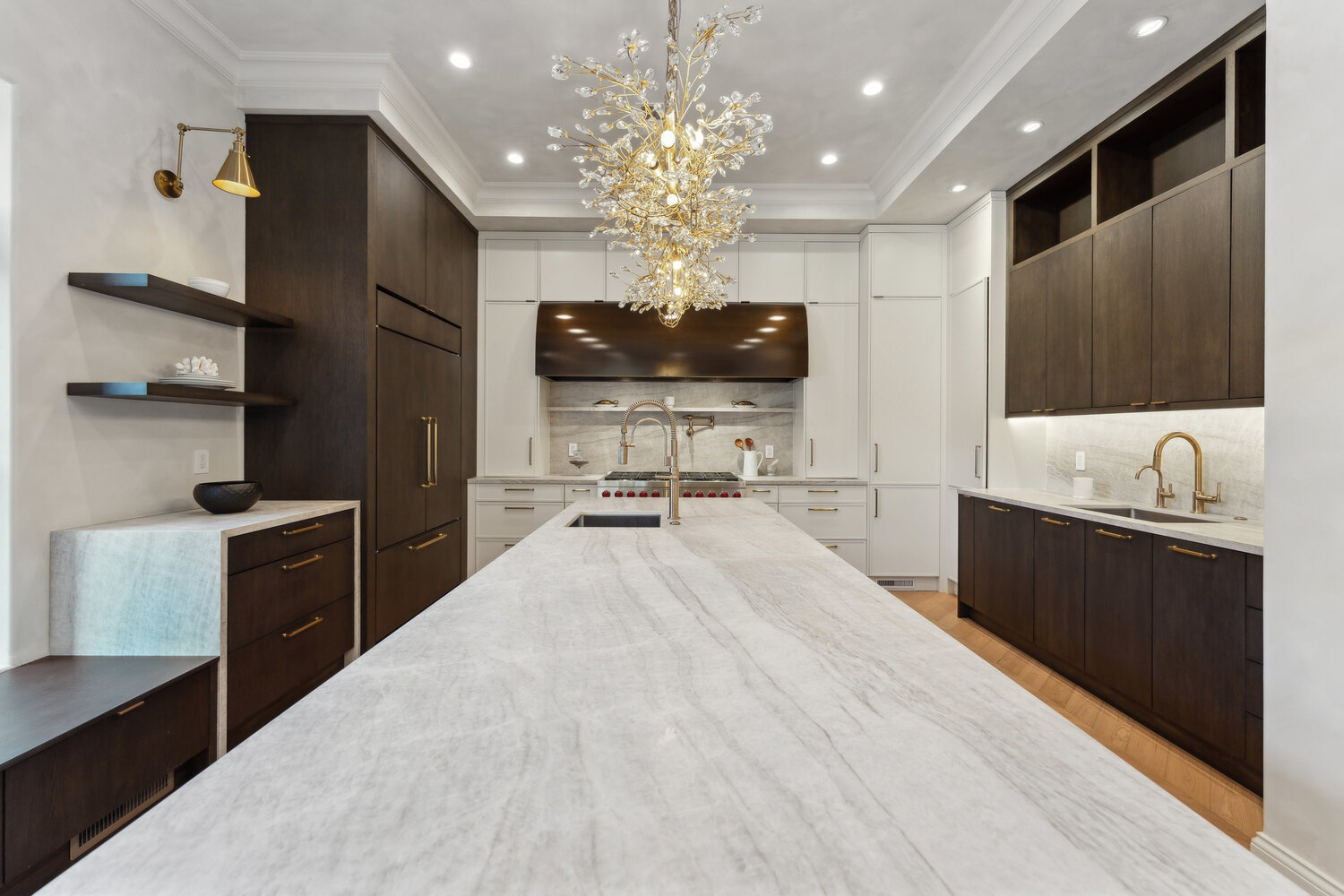 Elegant kitchen with marble island and gold chandeliers designed by DesignLab in Metro Washington custom home