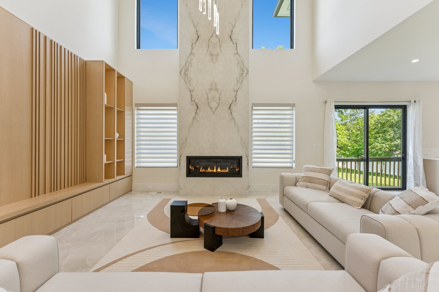 Modern open-concept living room with high ceilings and marble feature wall by DesignLab in Kalorama, DC