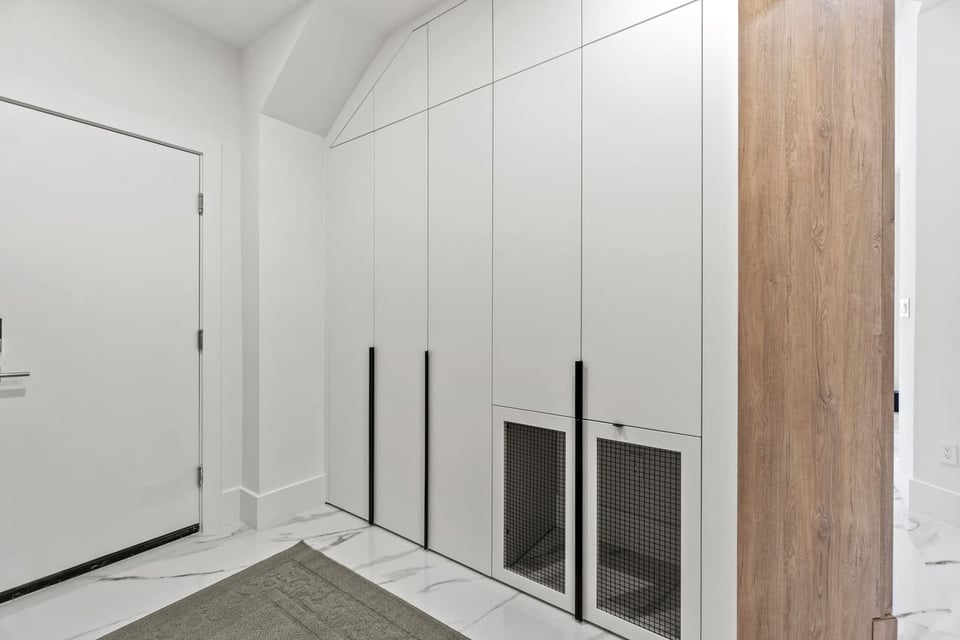 Custom entryway storage cabinetry with integrated pet enclosures by DesignLab in Washington DC Metro