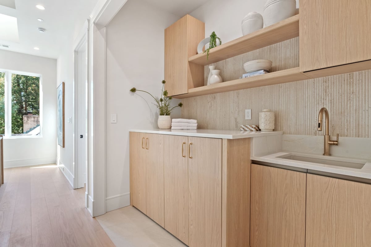 laundry room remodel with neutral cabinetry and shelving