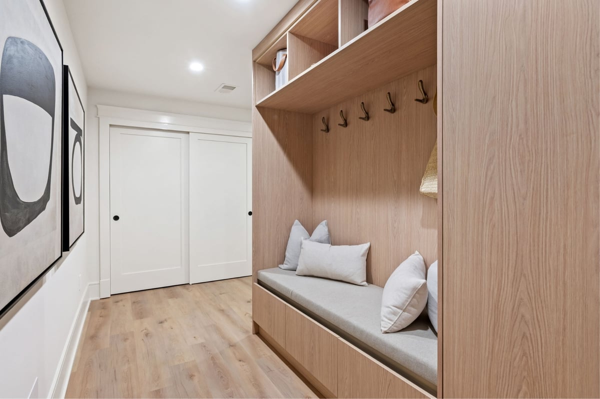 luxury mudroom design with hooks and bench seating