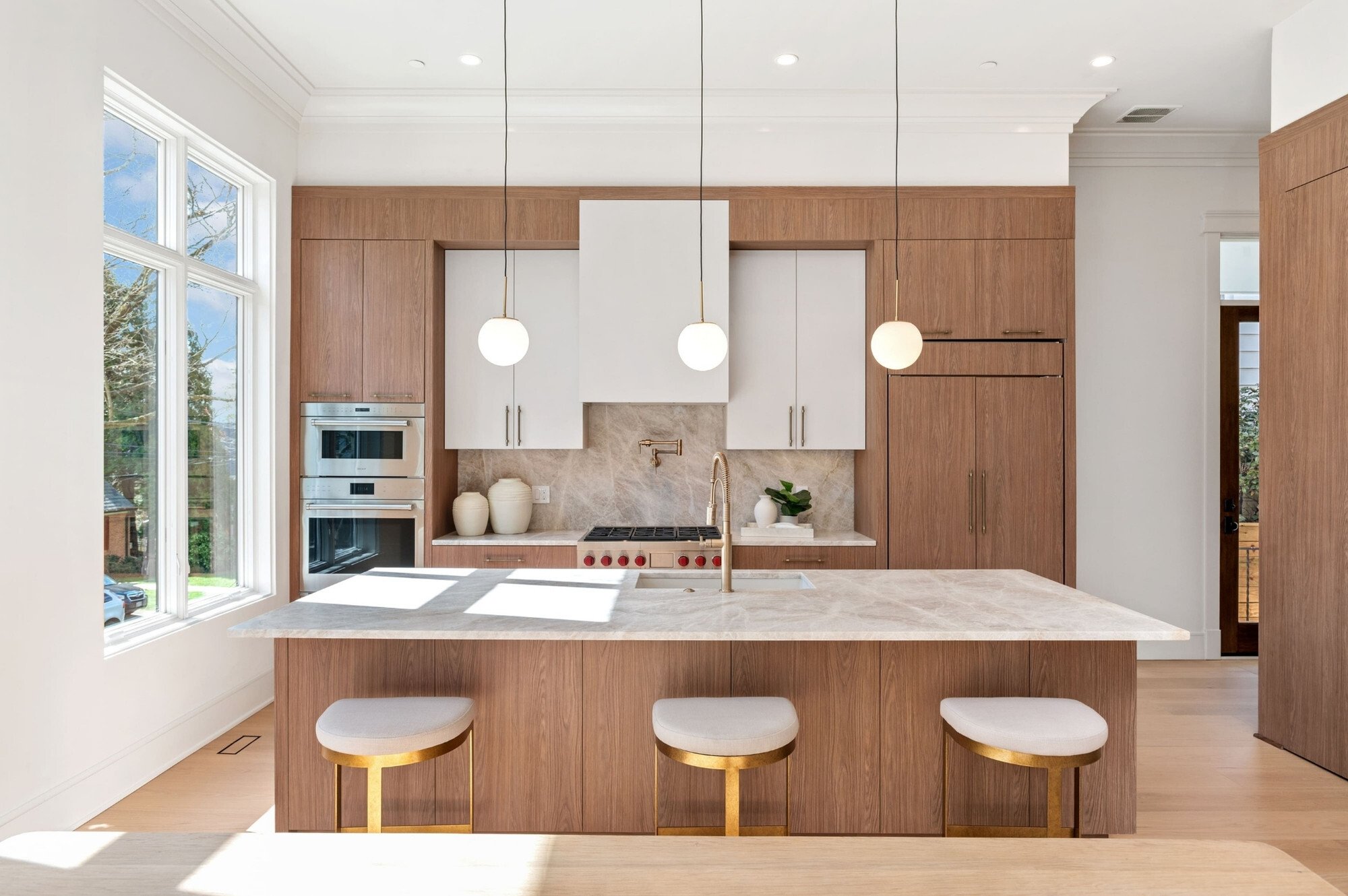neutral modern kitchen remodel in dc with flat panel cabinets and bar stool seating at kitchen island