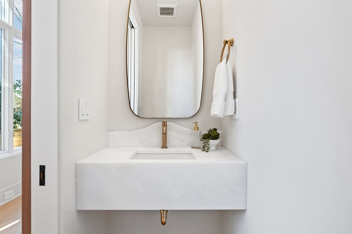 powder room sink with gold fixtures in bathroom remodel in dc
