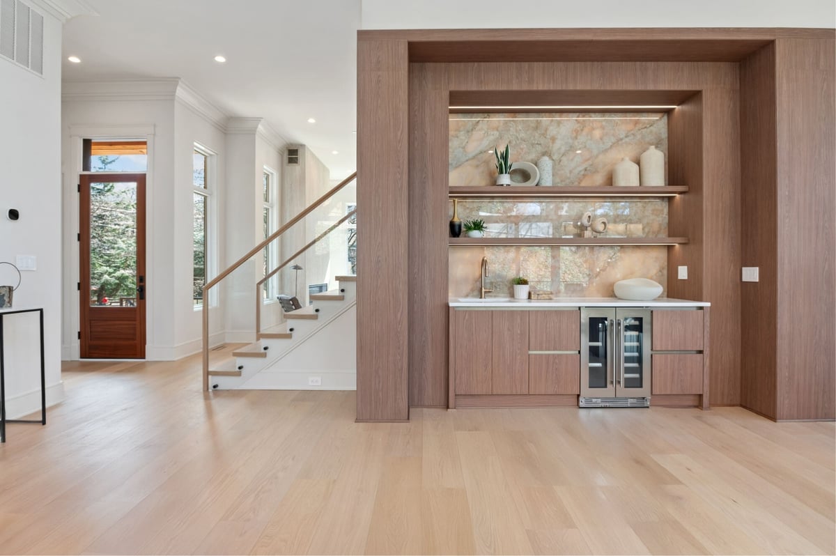 wet bar, stairway, and entryway view of open concept luxury remodel