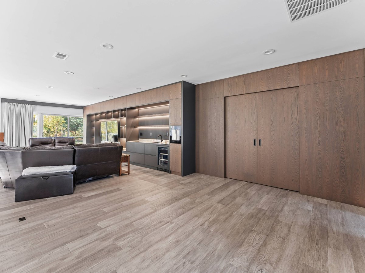 spacious upstairs entertainment area with wall to wall media center and flat panel cabinets
