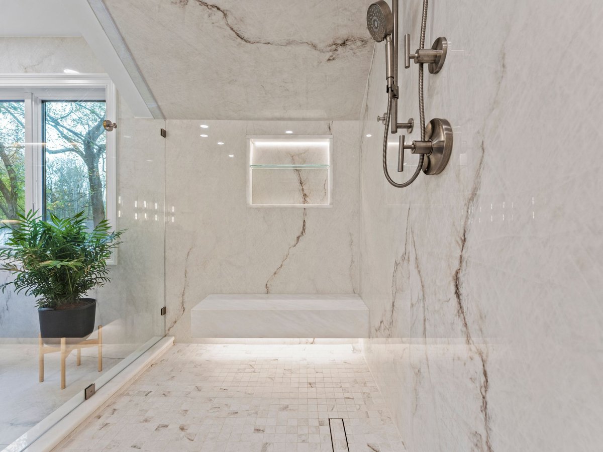 Luxury bathroom remodel in washington dc with large walk in shower with bench and glass door