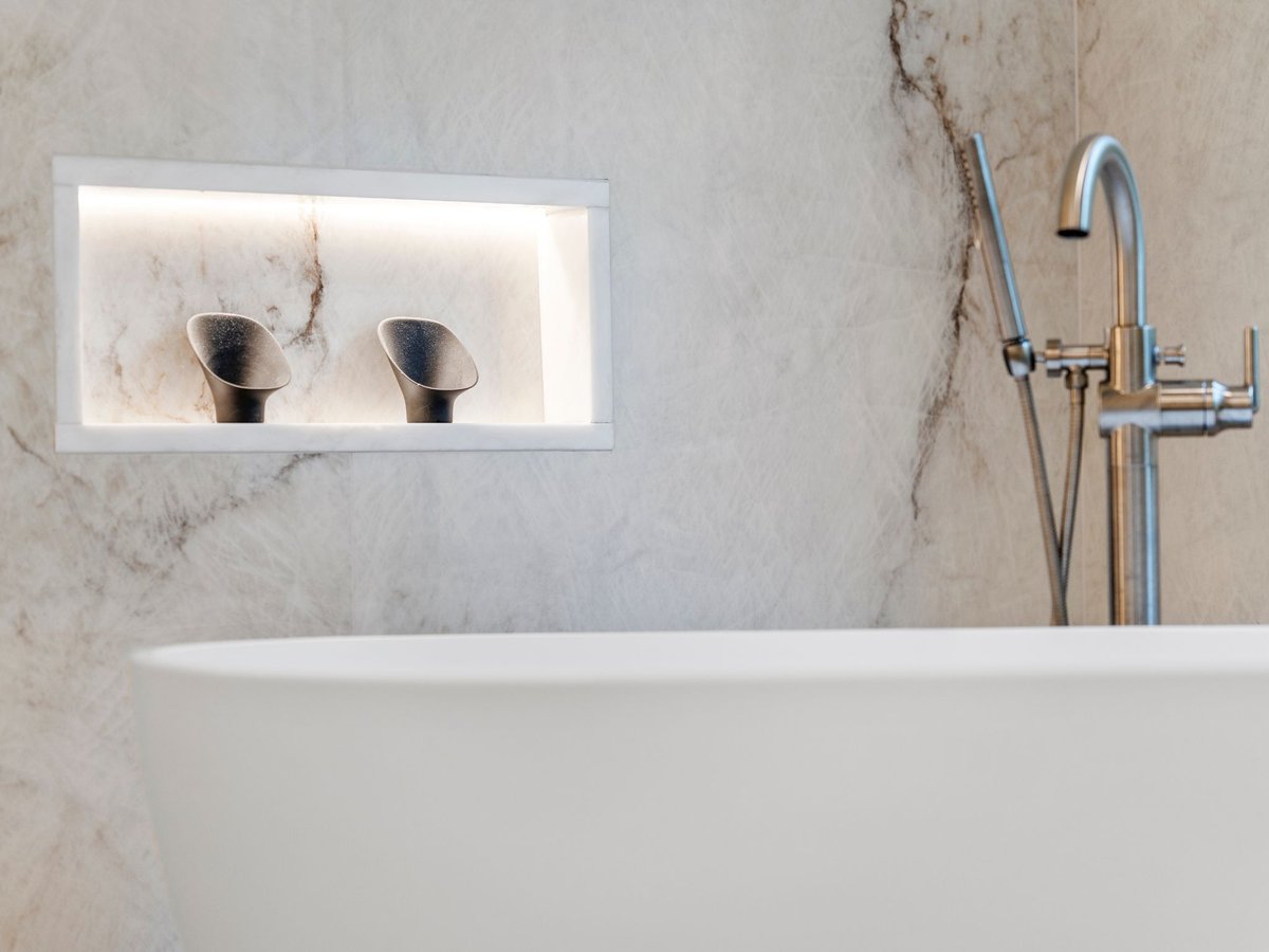 Luxury bathroom remodel in washington dc with large walk in shower with custom lit shelves