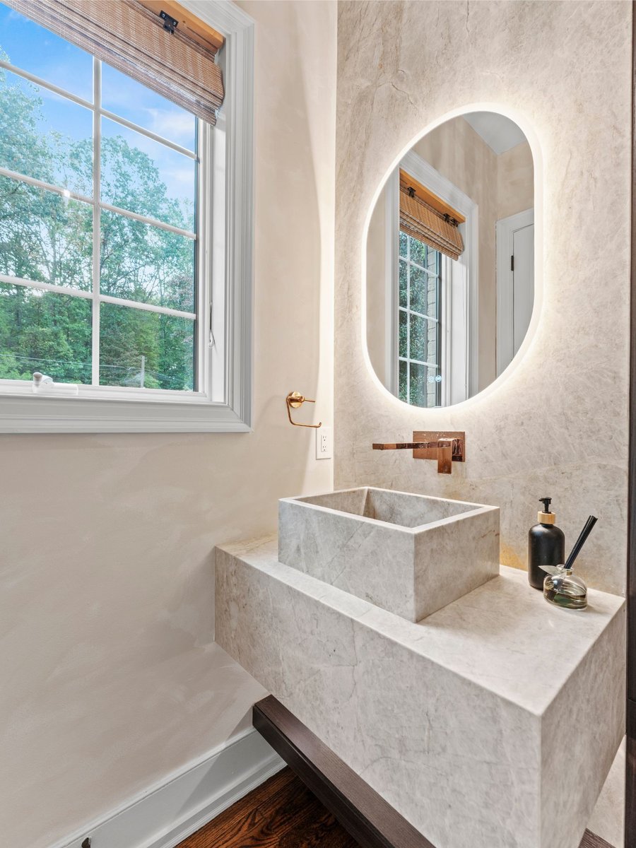 Luxury bathroom remodel in washington dc with stone sink and mirror