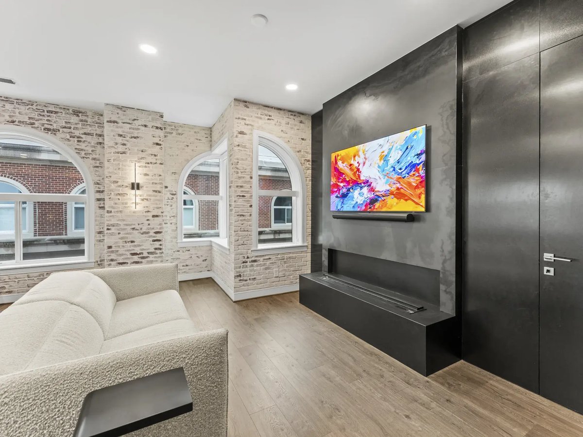 slater-condo-remodel-living-room-exposed-brick-black-plaster-fireplace