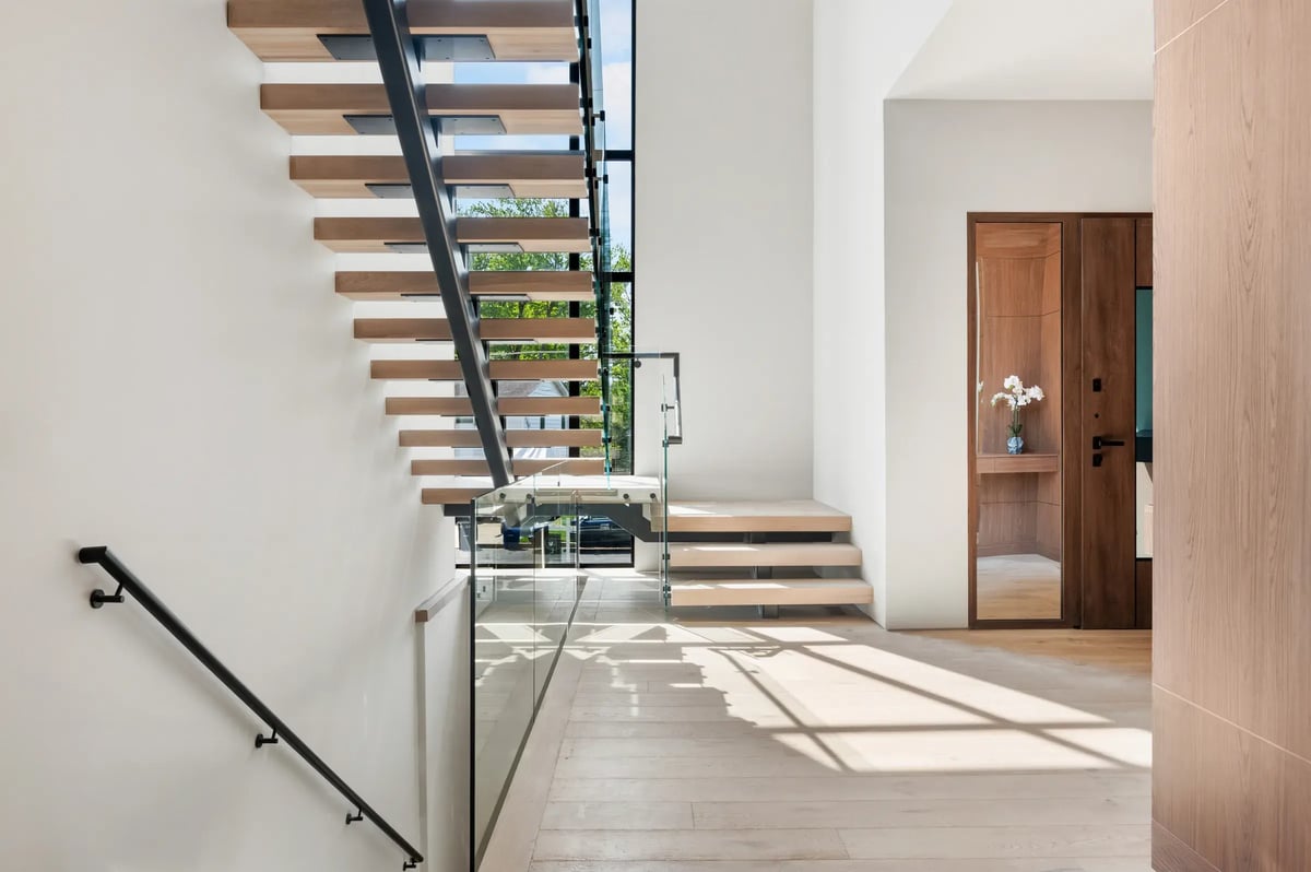 506-stephen-circle-entry-hall-floating-stairs-walnut-front-door