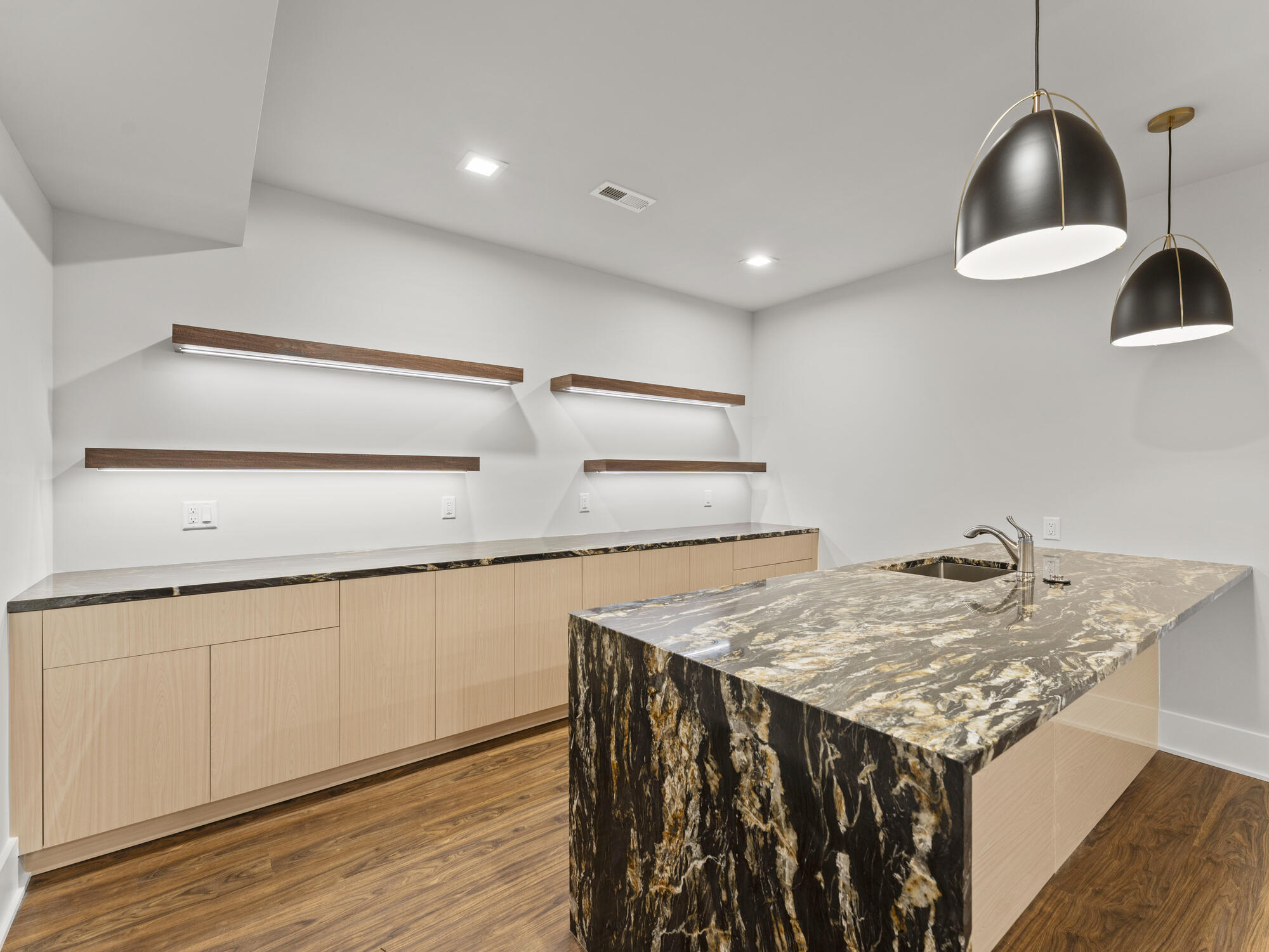 Modern basement wet bar with waterfall stone island by DesignLab in Northern Virginia whole home renovation