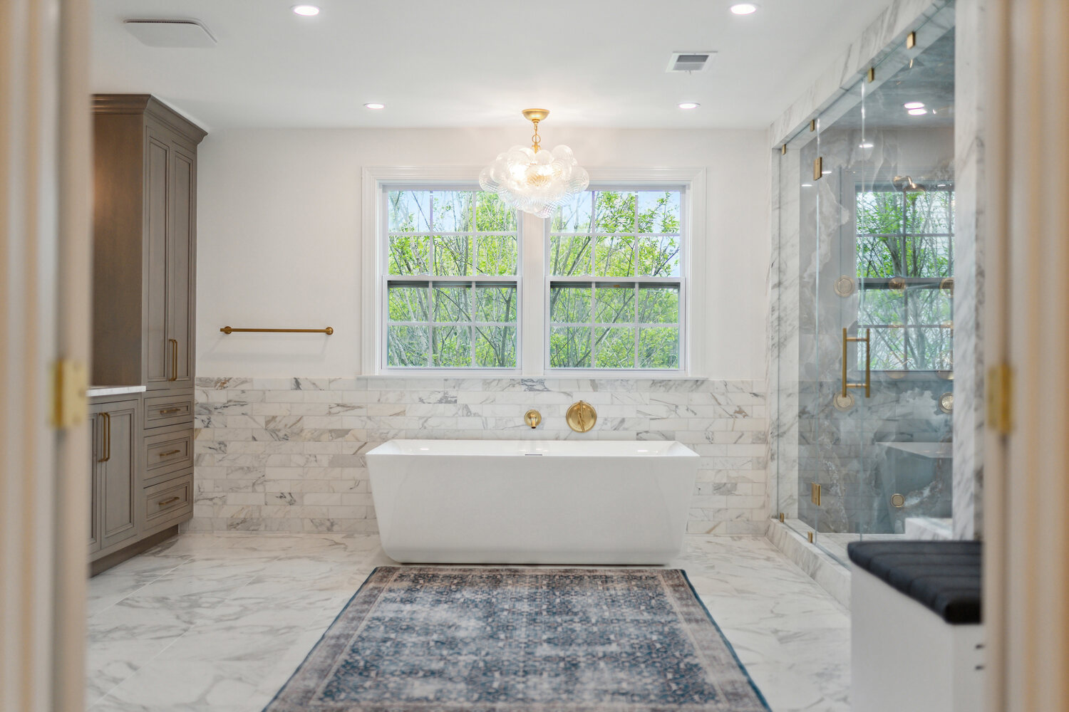 Freestanding tub and marble shower in luxury bathroom renovation by DesignLab in Metro Washington