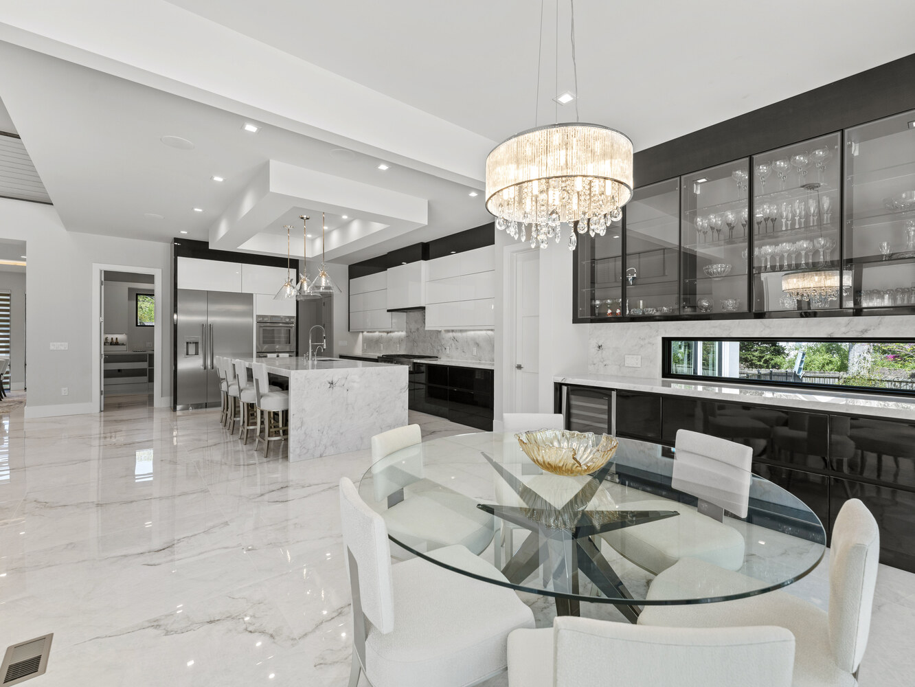 Contemporary dining area with chandelier and glass cabinets in Northern Virginia by DesignLab