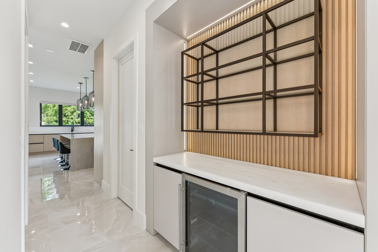 Contemporary pantry and bar design with built-in wine cooler by DesignLab in McLean