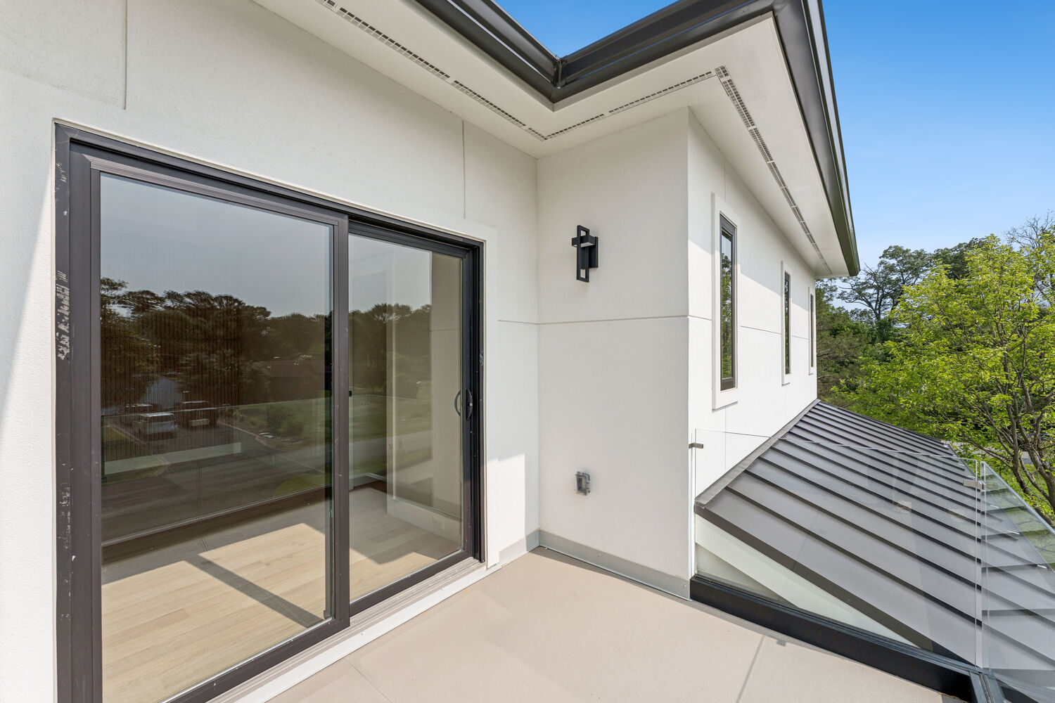 Private outdoor space remodel with glass railing by DesignLab in Arlington, Virginia