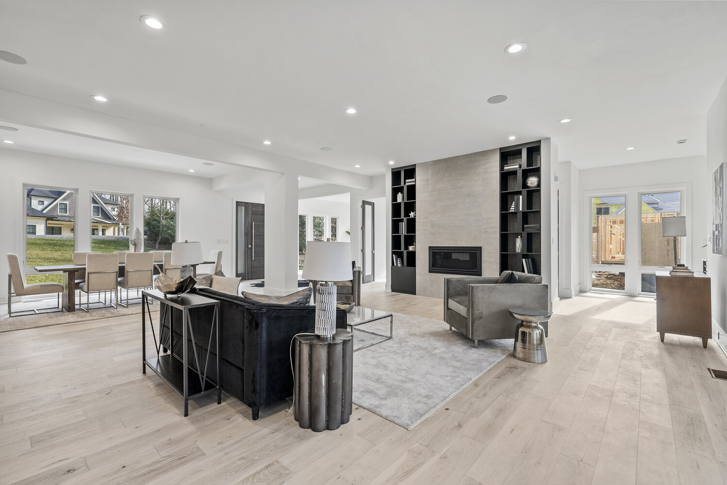 Bright living room with modern fireplace and built-ins in River Oaks whole home by DesignLab