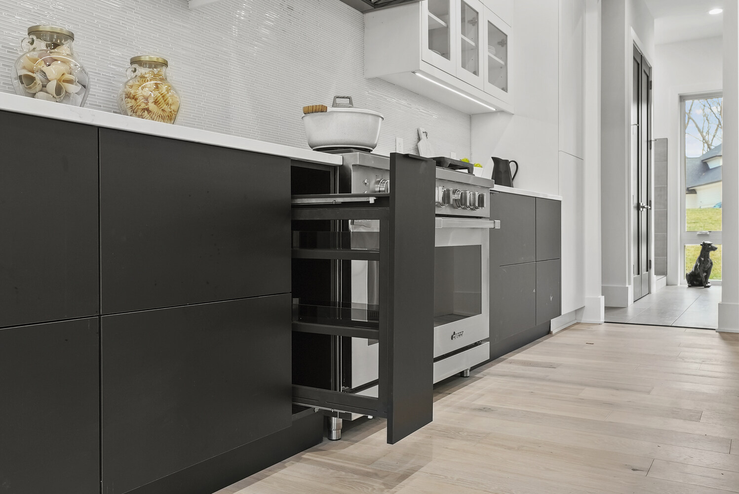 Pull-out spice drawer next to range in DesignLab’s River Oaks kitchen renovation