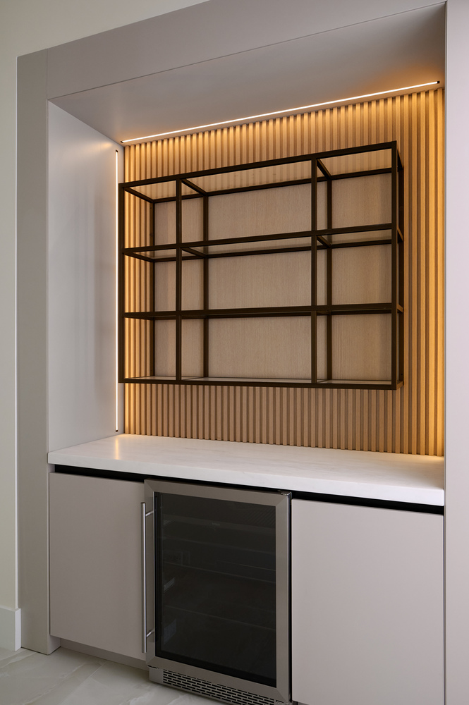 Modern built-in bar with bronze shelving and LED lighting in a custom DesignLab home in Washington, DC