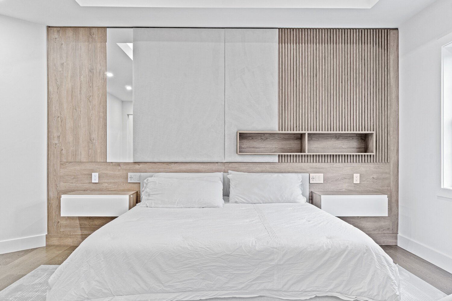 Bright modern bedroom with Scandinavian-style wood paneling in a custom DesignLab home in Oakton, VA