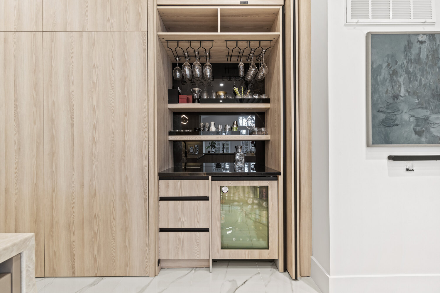 Built-in bar area with glassware storage and beverage fridge in a DesignLab custom home in Metro Washington