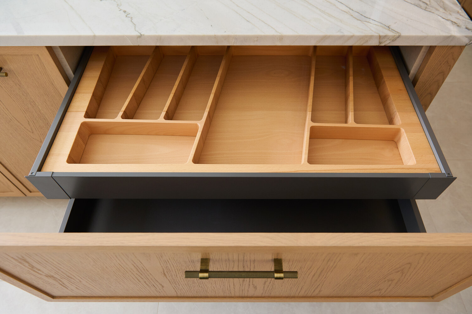 Custom wood drawer insert for utensils in a luxury kitchen by DesignLab in Metro Washington