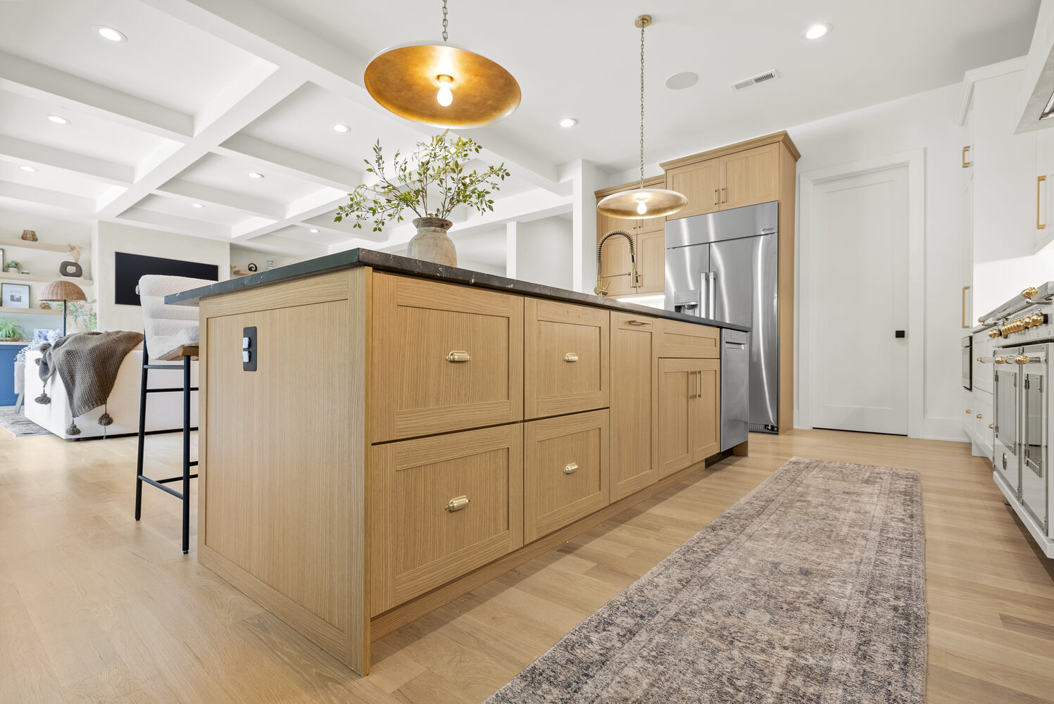 View of custom kitchen island with pendant lights and bar seating in a Metro Washington home by DesignLab