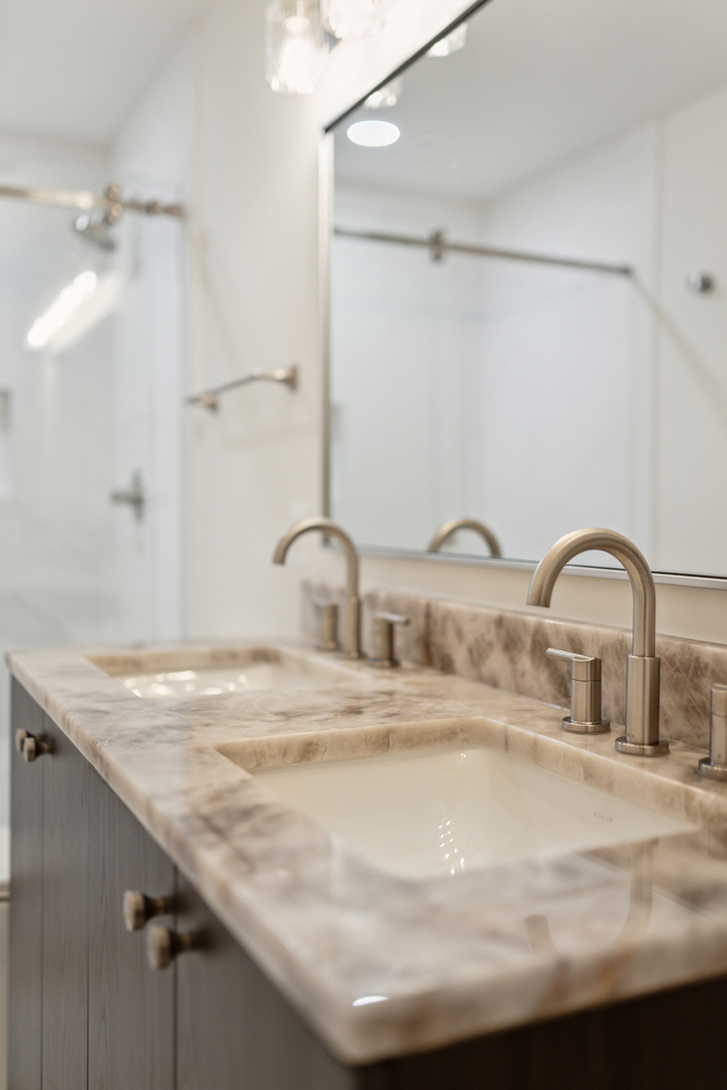 Close-up of marble double vanity with brushed nickel faucets by DesignLab in a Metro Washington custom home