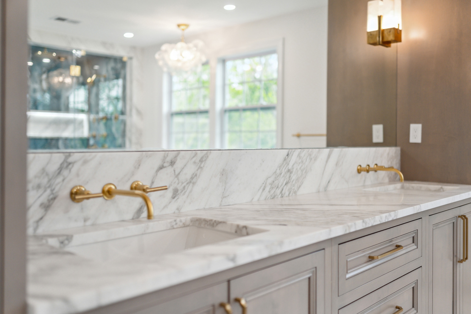 Dual vanity with marble backsplash and brass fixtures by DesignLab in a Washington, DC custom home