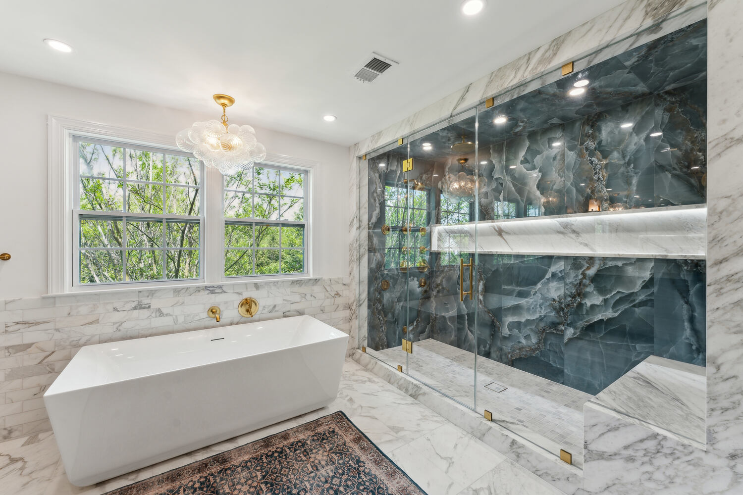 Luxurious bathroom with freestanding tub and blue onyx steam shower by DesignLab in Metro Washington