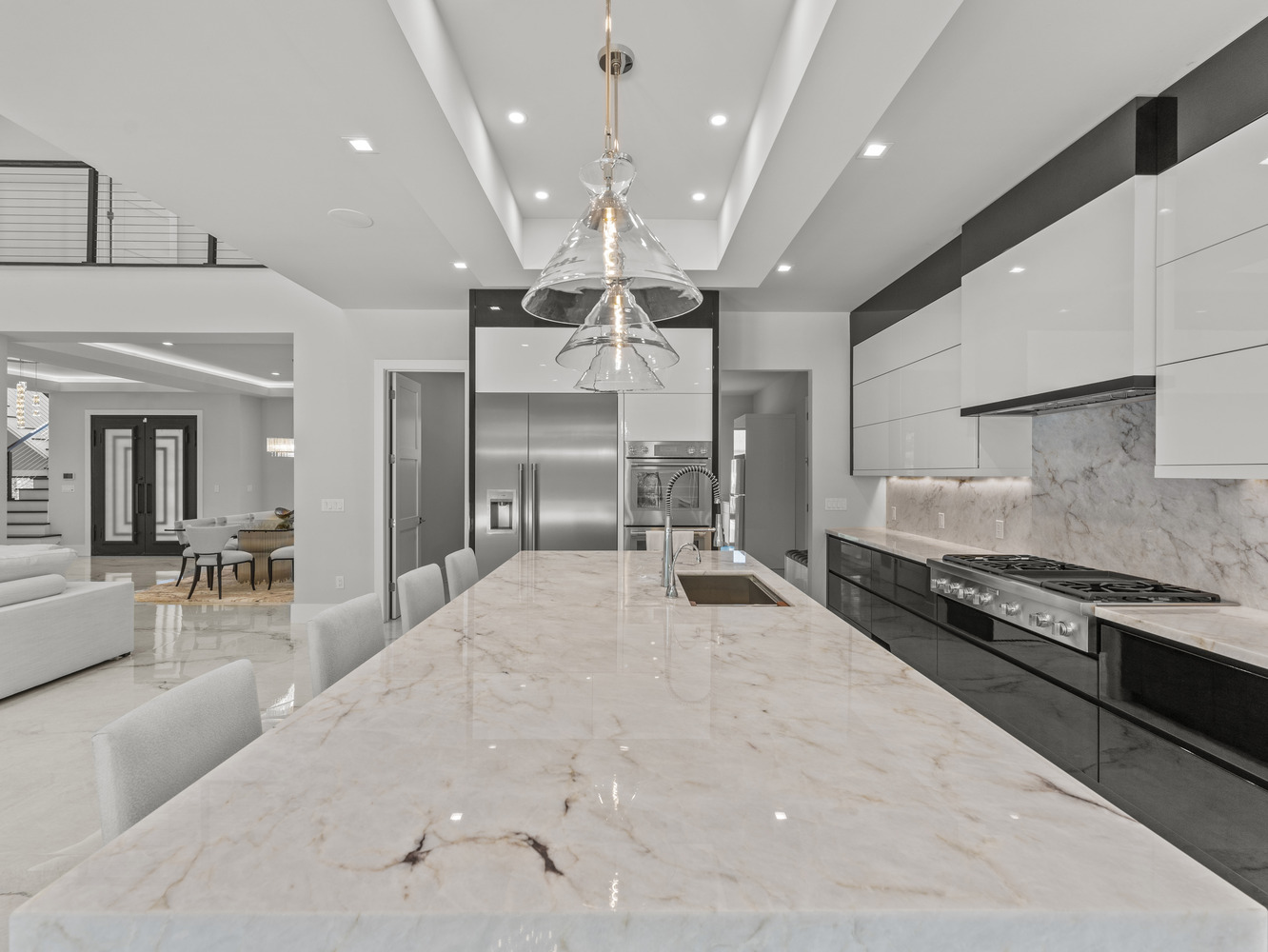 Open-concept luxury kitchen with waterfall island and high-gloss cabinetry by DesignLab in Metro Washington